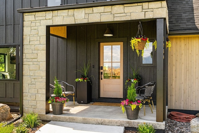 7980 Balsam, Bozeman, MT 59718 - view of exterior entry featuring board and batten siding, stone siding, and covered porch