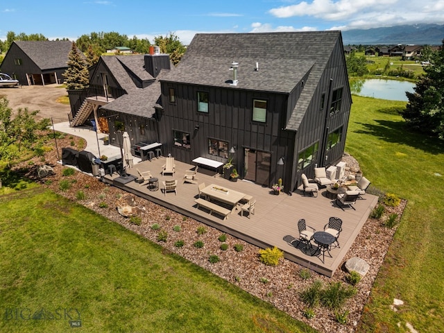 7980 Balsam, Bozeman, MT 59718 - back of house featuring a deck with water view, an outdoor hangout area, and a shingled roof