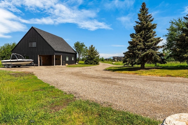 7980 Balsam, Bozeman, MT 59718 - view of property exterior with a garage, dirt driveway, an outdoor structure, and a lawn