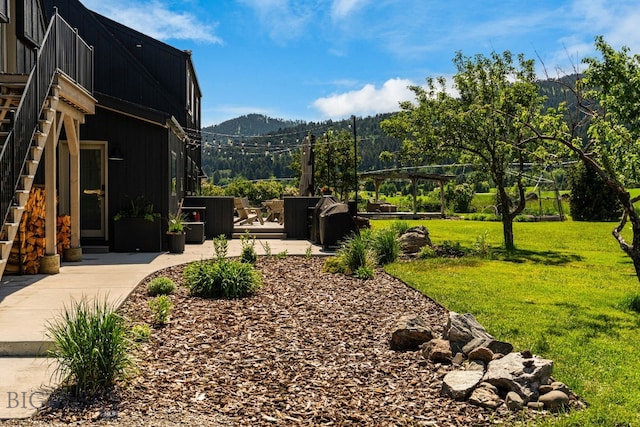 7980 Balsam, Bozeman, MT 59718 - view of grassy yard with a mountain view and stairs