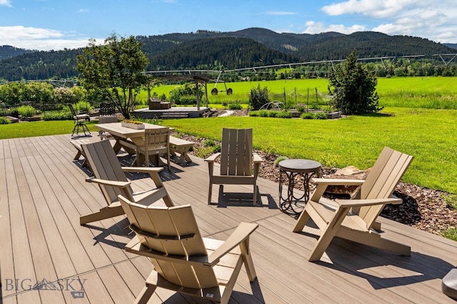 7980 Balsam, Bozeman, MT 59718 - wooden deck featuring a mountain view, a yard, outdoor dining space, and a forest view