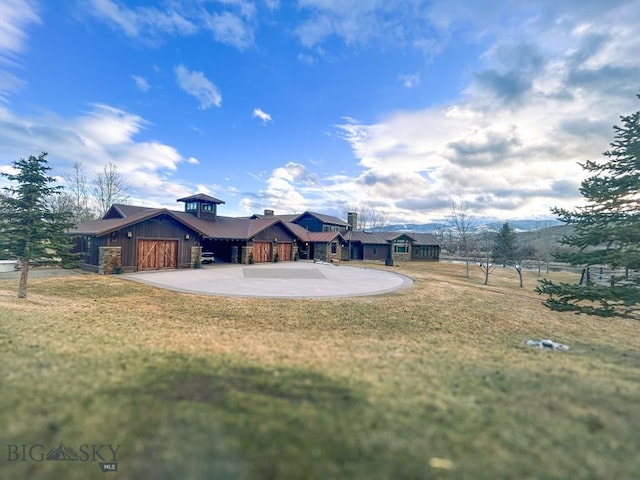 201 Cotton Willow, Melrose, MT 59743 - back of property featuring board and batten siding, concrete driveway, and a garage