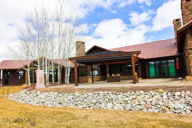 201 Cotton Willow, Melrose, MT 59743 - rear view of property featuring a chimney, a patio, and metal roof