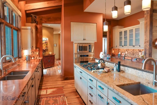 201 Cotton Willow, Melrose, MT 59743 - kitchen featuring a sink, appliances with stainless steel finishes, light wood-style flooring, and tasteful backsplash