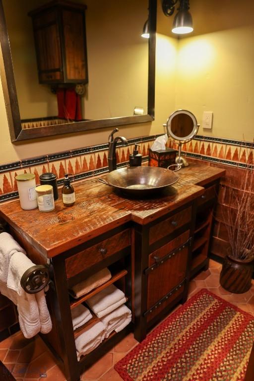 201 Cotton Willow, Melrose, MT 59743 - bathroom featuring tile patterned flooring, vanity, a wainscoted wall, and tile walls