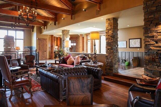 201 Cotton Willow, Melrose, MT 59743 - living area featuring ornate columns, wood finished floors, beam ceiling, and high vaulted ceiling