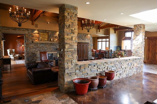 201 Cotton Willow, Melrose, MT 59743 - living room with decorative columns, beam ceiling, a chandelier, and recessed lighting