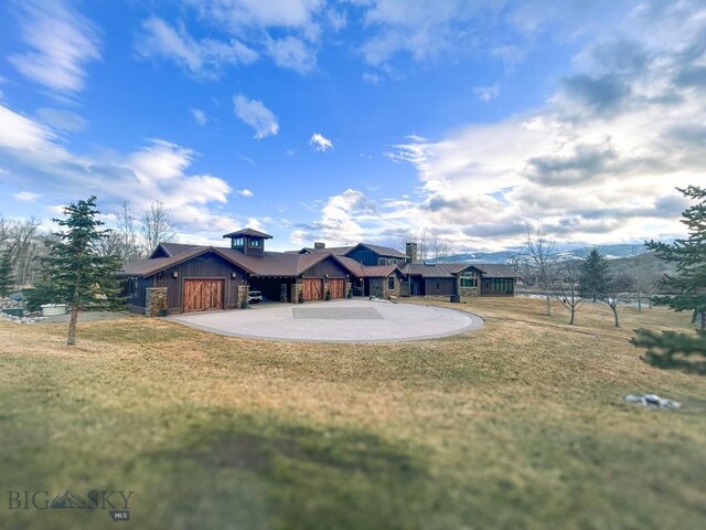 201 Cotton Willow, Melrose, MT 59743 - view of front of house with driveway, a front lawn, and board and batten siding
