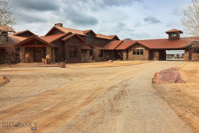 201 Cotton Willow, Melrose, MT 59743 - craftsman-style home featuring stone siding, metal roof, and dirt driveway