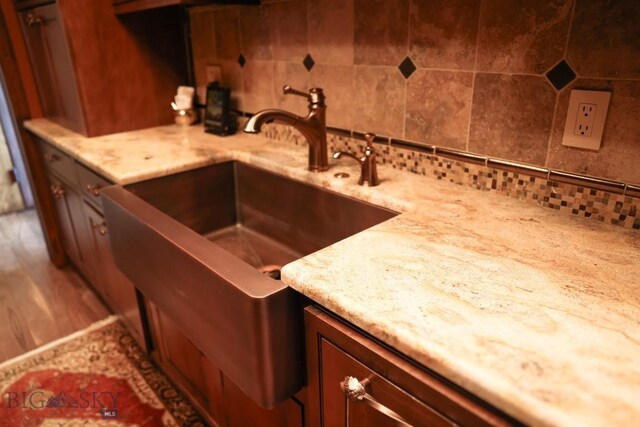 201 Cotton Willow, Melrose, MT 59743 - kitchen with decorative backsplash, a sink, and light stone countertops