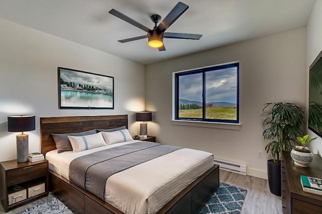 1104 Ridgeview Trl, Livingston, MT 59047 - bedroom featuring baseboard heating, wood finished floors, and ceiling fan