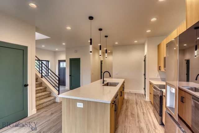 1104 Ridgeview Trl, Livingston, MT 59047 - kitchen featuring modern cabinets, light wood-style floors, light brown cabinetry, a kitchen island with sink, and recessed lighting