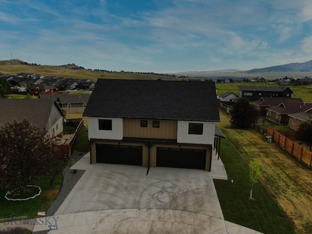 1104 Ridgeview Trl, Livingston, MT 59047 - view of front facade featuring an attached garage, a residential view, a shingled roof, and concrete driveway