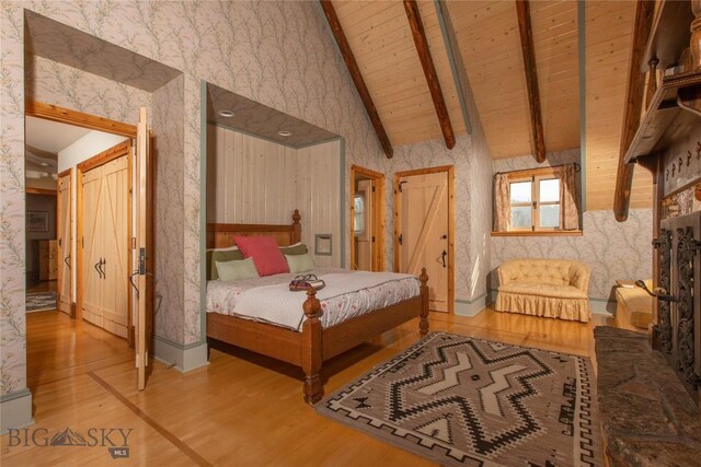 31255 Ninemile Rd, Huson, MT 59846 - bedroom with wallpapered walls, wood finished floors, wood ceiling with exposed beams, high vaulted ceiling, and baseboards