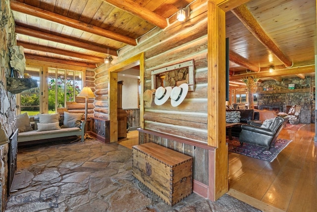 31255 Ninemile Rd, Huson, MT 59846 - hallway with rustic walls, wooden ceiling with exposed beams, and wood finished floors