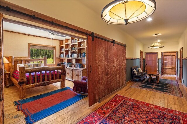 31255 Ninemile Rd, Huson, MT 59846 - bedroom with a barn door and wood finished floors