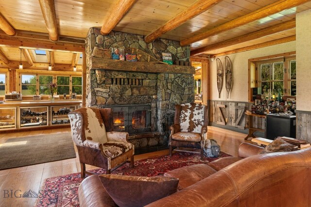 31255 Ninemile Rd, Huson, MT 59846 - living room featuring hardwood / wood-style flooring, a fireplace, wooden ceiling with exposed beams, and wainscoting