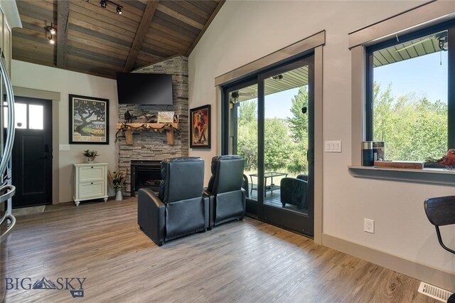 520 Pennsylvania St E Unit 10, Anaconda, MT 59711 - living area featuring lofted ceiling with beams, wood finished floors, wooden ceiling, and a fireplace