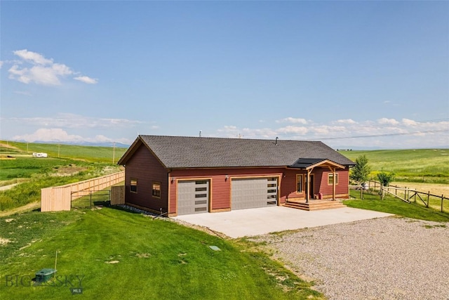 49 Wild Rye Pl, Three Forks, MT 59752 - view of front of house with gravel driveway, a garage, roof with shingles, and a view of countryside