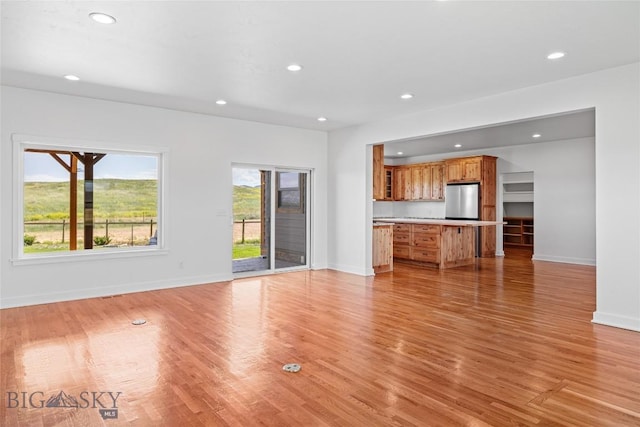 49 Wild Rye Pl, Three Forks, MT 59752 - unfurnished living room with recessed lighting and light wood finished floors
