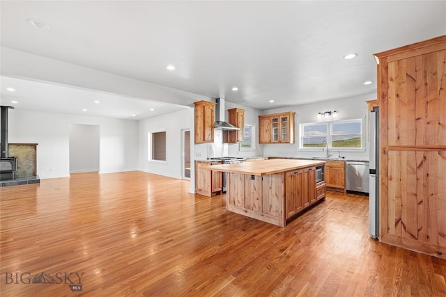 49 Wild Rye Pl, Three Forks, MT 59752 - kitchen with wooden counters, wall chimney exhaust hood, appliances with stainless steel finishes, a kitchen island, and recessed lighting
