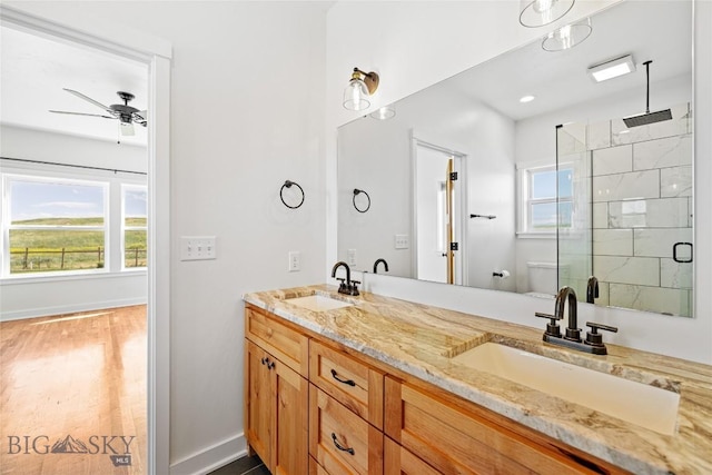 49 Wild Rye Pl, Three Forks, MT 59752 - bathroom featuring a stall shower, double vanity, ceiling fan, and wood finished floors