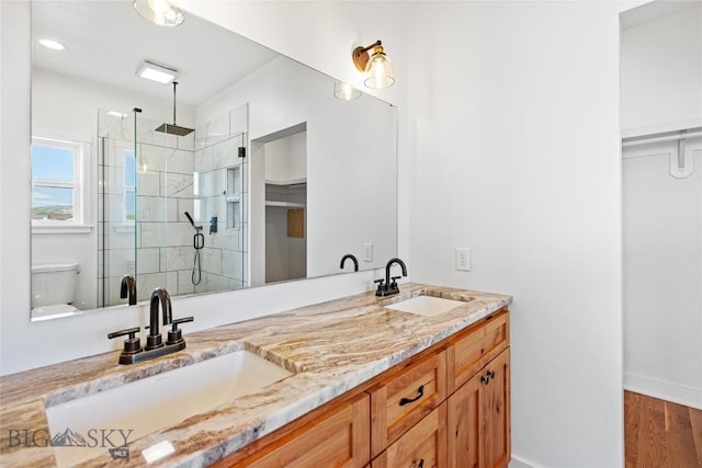49 Wild Rye Pl, Three Forks, MT 59752 - full bath featuring a stall shower, double vanity, a spacious closet, and wood finished floors