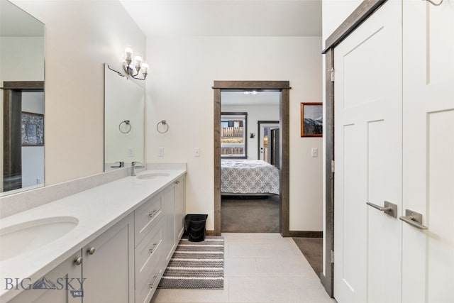 104 Albrey Trl Unit C, Bozeman, MT 59718 - full bathroom with double vanity, baseboards, ensuite bath, and tile patterned floors