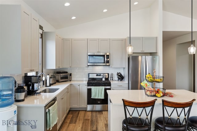 104 Albrey Trl Unit C, Bozeman, MT 59718 - kitchen with appliances with stainless steel finishes, lofted ceiling, a breakfast bar area, light countertops, and a sink