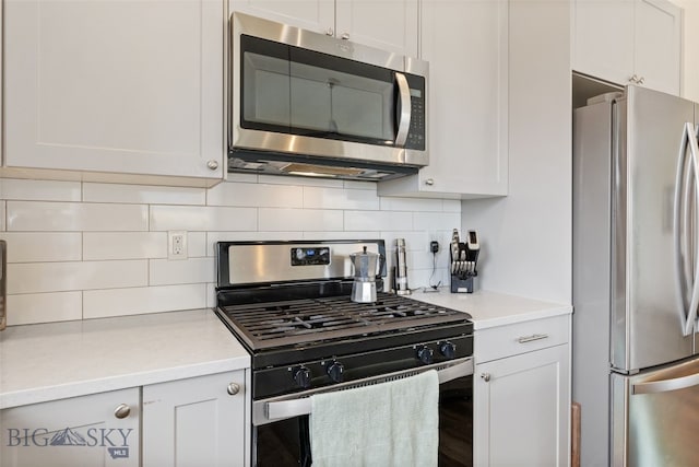 104 Albrey Trl Unit C, Bozeman, MT 59718 - kitchen with appliances with stainless steel finishes, decorative backsplash, light countertops, and white cabinetry