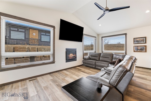 104 Albrey Trl Unit C, Bozeman, MT 59718 - living area with a glass covered fireplace, vaulted ceiling, a ceiling fan, wood finished floors, and baseboards