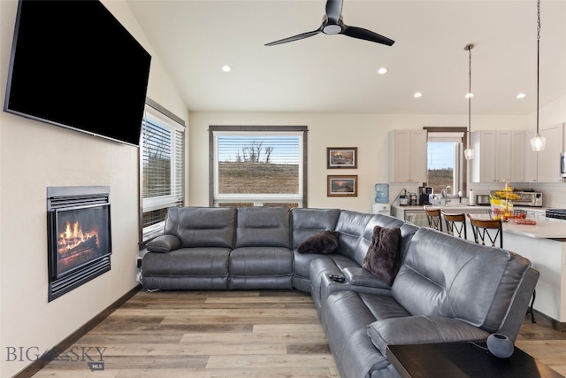 104 Albrey Trl Unit C, Bozeman, MT 59718 - living area featuring a ceiling fan, healthy amount of natural light, light wood-type flooring, recessed lighting, and a glass covered fireplace