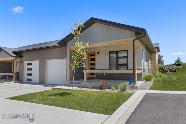 104 Albrey Trl Unit C, Bozeman, MT 59718 - view of front of property with covered porch, a front yard, an attached garage, and concrete driveway