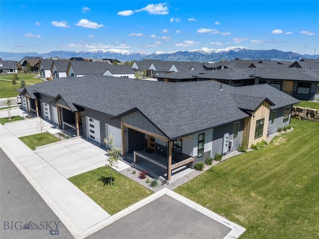 104 Albrey Trl Unit C, Bozeman, MT 59718 - view of front of home featuring a residential view, a shingled roof, concrete driveway, a mountain view, and a front lawn