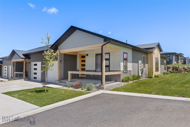 104 Albrey Trl Unit C, Bozeman, MT 59718 - view of front facade with covered porch, a front yard, driveway, and a garage