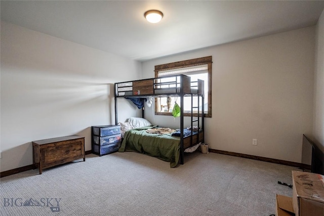 bedroom featuring carpet and baseboards
