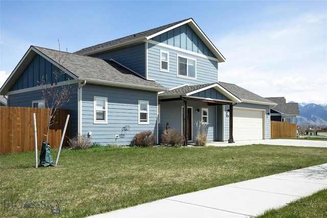 view of front facade with board and batten siding, driveway, fence, a garage, and a front yard