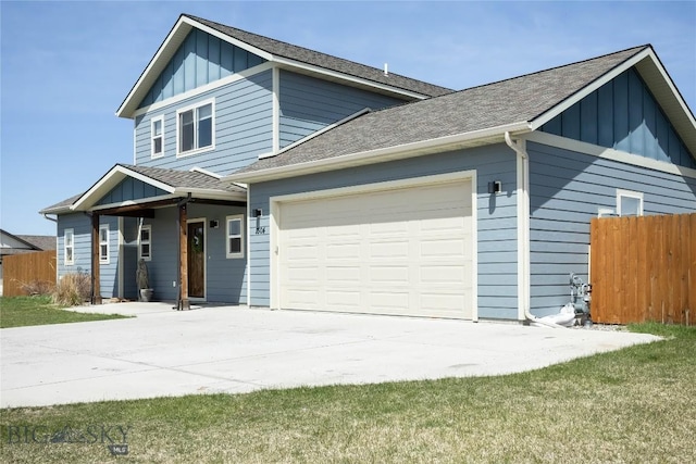 view of front facade featuring driveway, an attached garage, fence, and board and batten siding