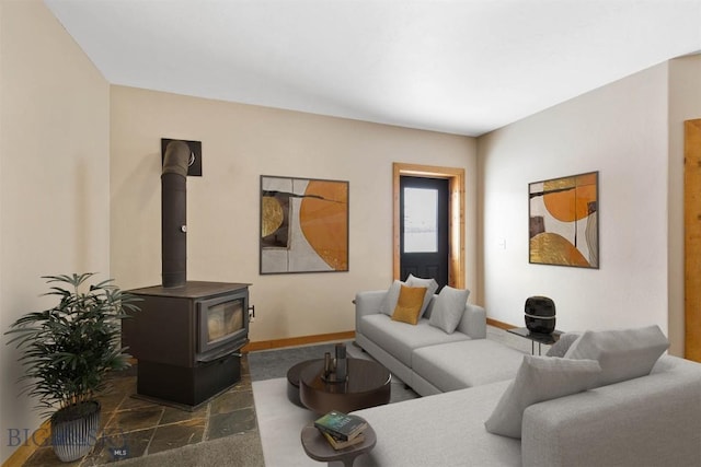 480 Moose Crossing Rd, Gallatin Gateway, MT 59730 - living room featuring a wood stove and baseboards