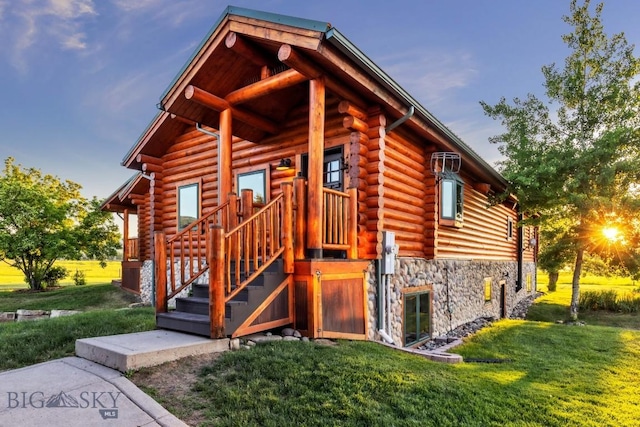 480 Moose Crossing Rd, Gallatin Gateway, MT 59730 - view of front facade featuring log exterior, stone siding, and a front lawn