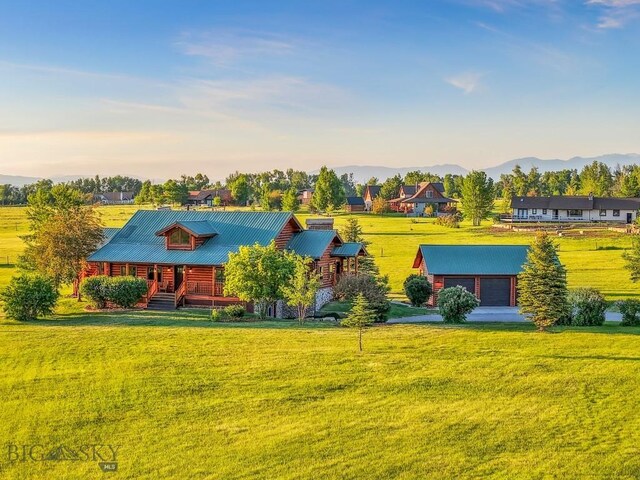 480 Moose Crossing Rd, Gallatin Gateway, MT 59730 - view of front of home with covered porch, a front yard, a metal roof, and a mountain view