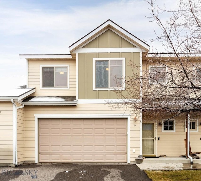 818 Quail Run Unit B, Bozeman, MT 59718 - view of front of house featuring board and batten siding, an attached garage, and driveway