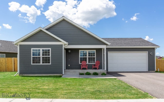 2300 Sturnella Ln, Belgrade, MT 59714 - view of front of house featuring covered porch, asphalt driveway, and a garage