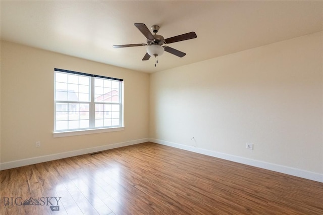 2300 Sturnella Ln, Belgrade, MT 59714 - empty room featuring wood finished floors, baseboards, and ceiling fan