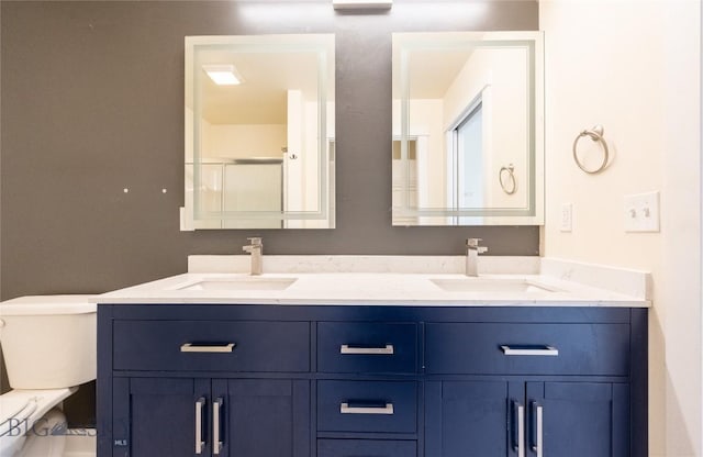 2300 Sturnella Ln, Belgrade, MT 59714 - full bath featuring double vanity, toilet, and an enclosed shower