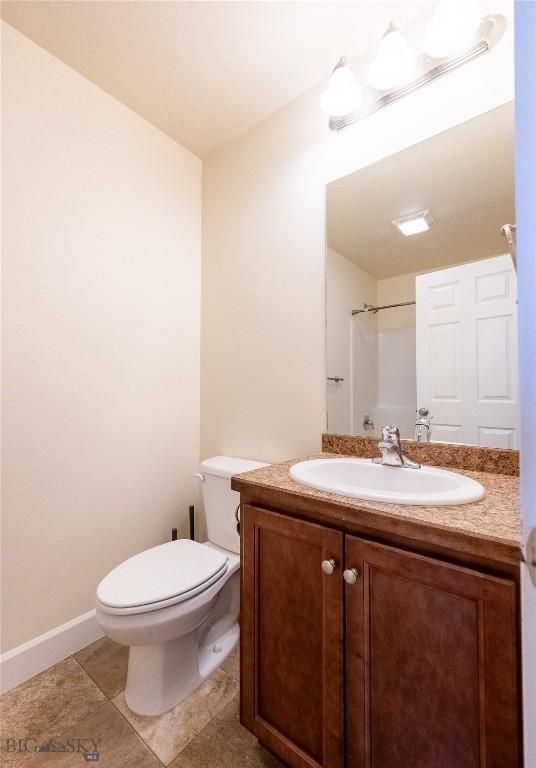 2300 Sturnella Ln, Belgrade, MT 59714 - bathroom featuring vanity, toilet, and baseboards