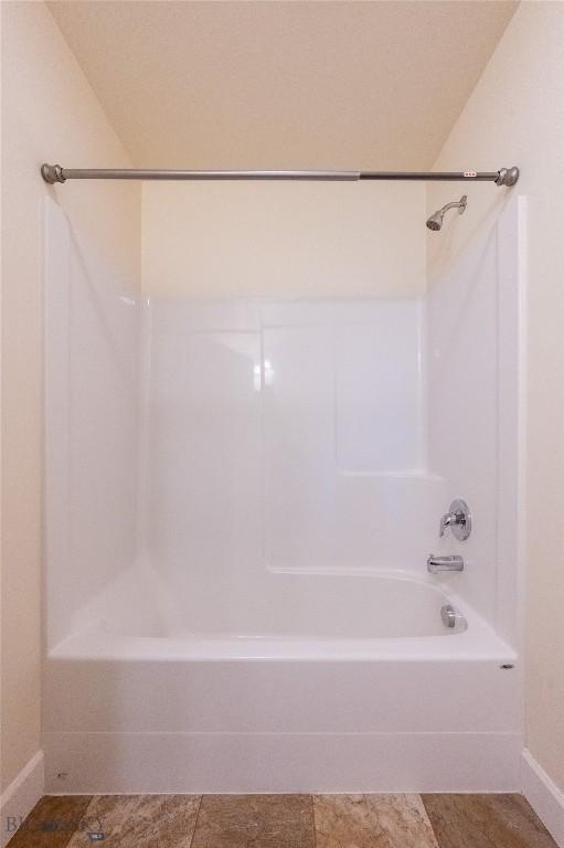 2300 Sturnella Ln, Belgrade, MT 59714 - full bathroom with baseboards and shower / washtub combination