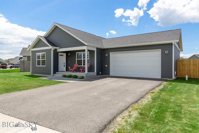 2300 Sturnella Ln, Belgrade, MT 59714 - single story home with a porch, asphalt driveway, a garage, and a shingled roof