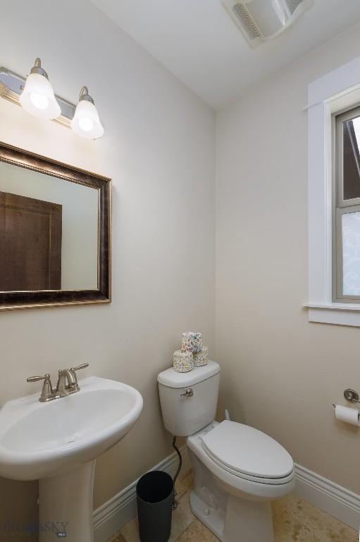 2026 Southbridge, Bozeman, MT 59718 - half bathroom with baseboards, toilet, a sink, and tile patterned flooring