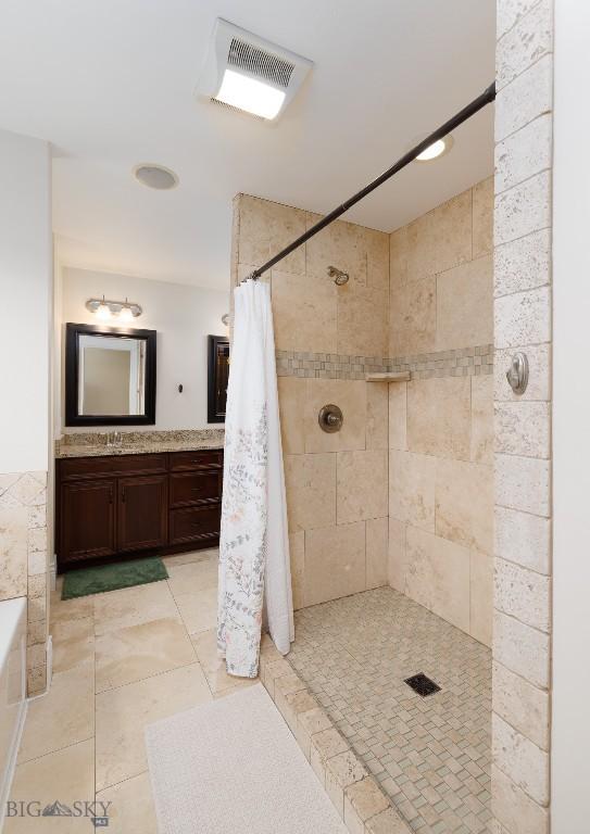 2026 Southbridge, Bozeman, MT 59718 - full bathroom with a tile shower, vanity, tile patterned flooring, and a tub to relax in